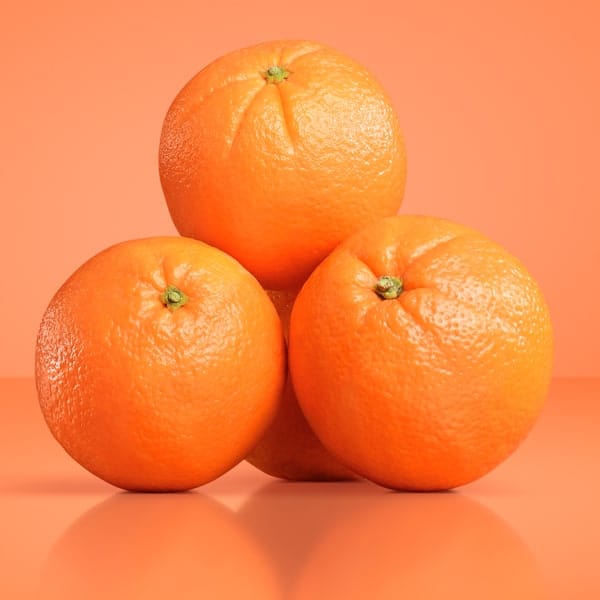 Three Navel oranges on an orange background